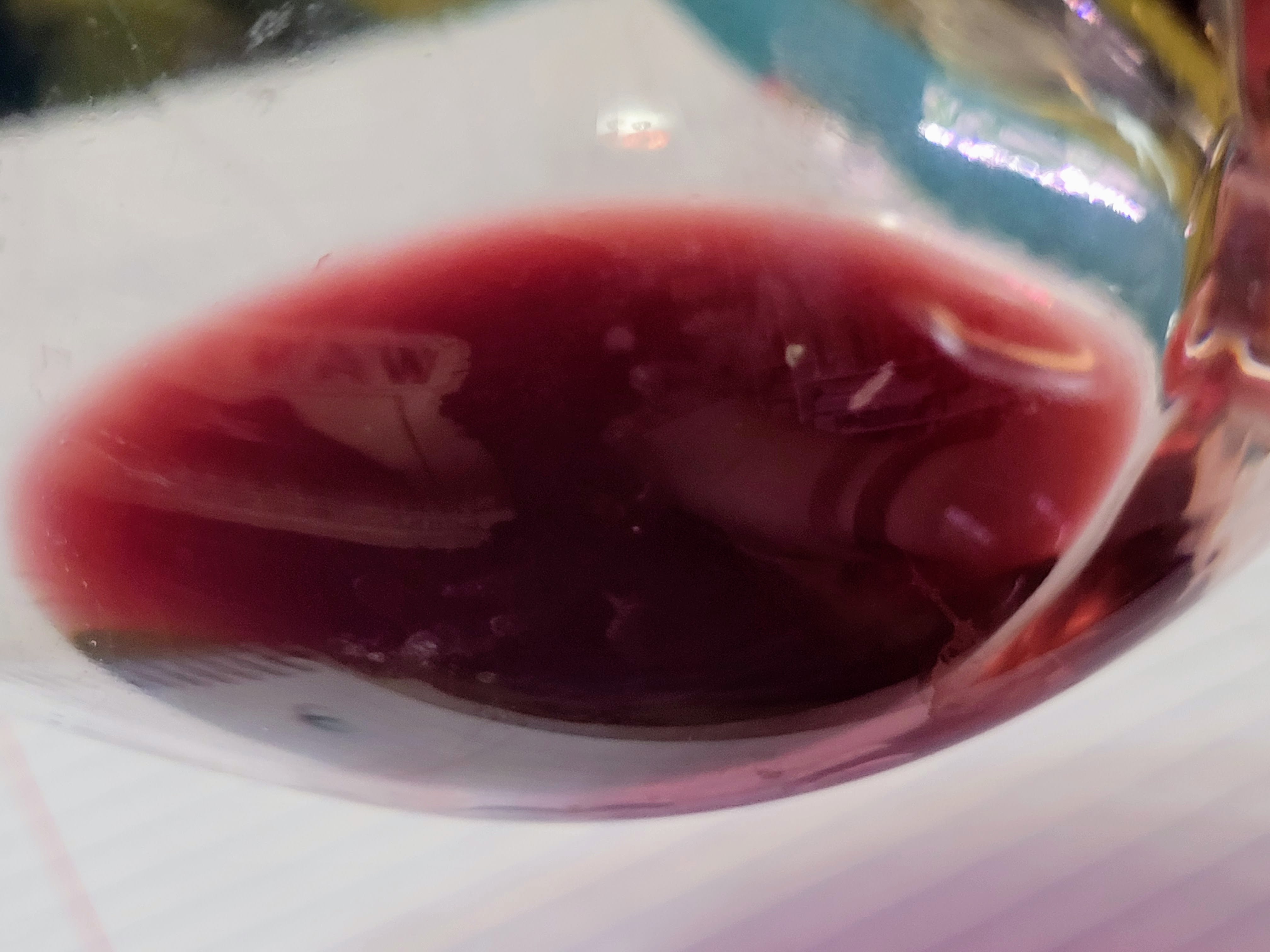 Red wine against white background.