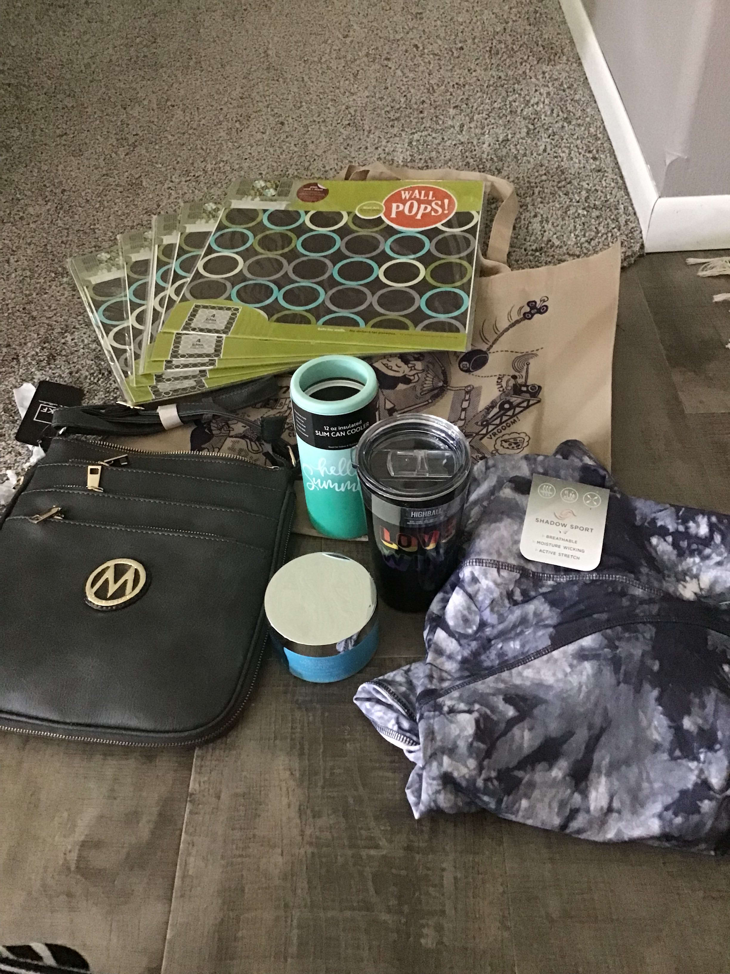 a cup, can holder, purse, sticky wall squares, 2x capri leggings, lotion