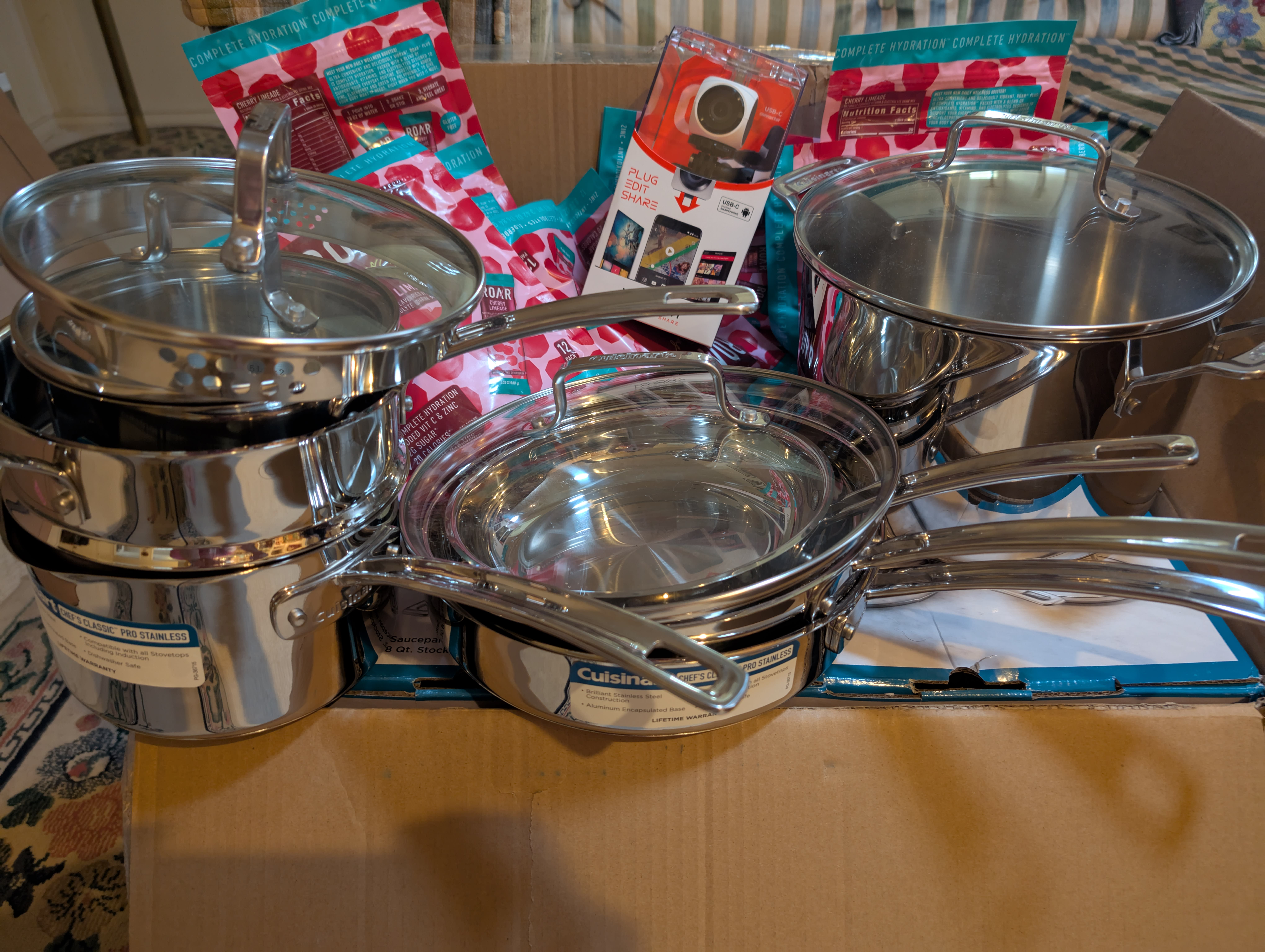 11 Cuisinart pots, pans, and lids, 10 bags of drink mix, and a vupoint camera